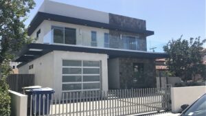 Modern two-story house with balcony and garage.