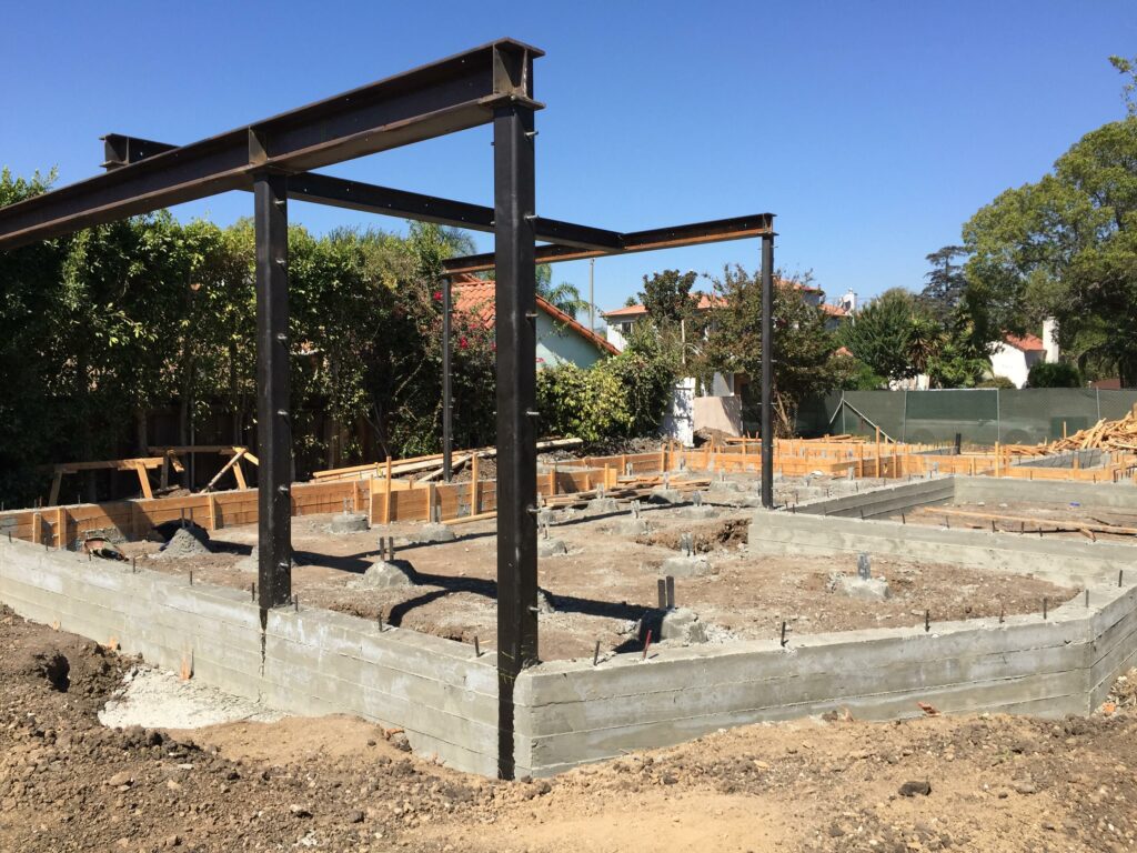 House foundation construction site with steel beams.