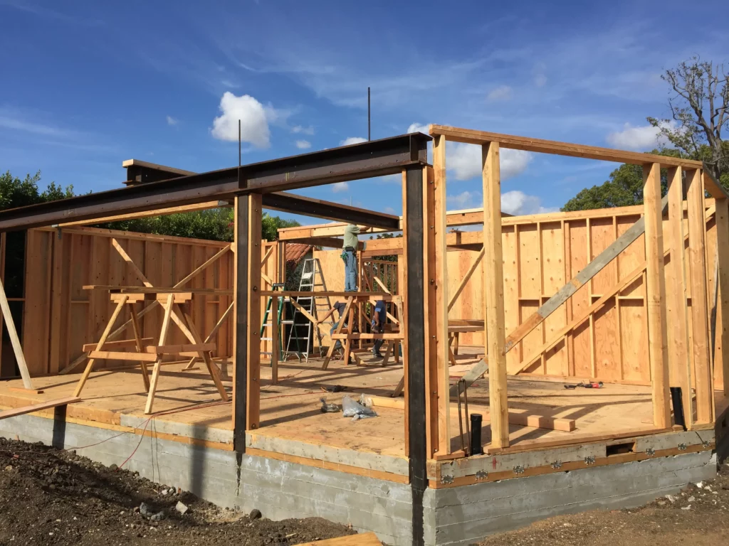 House construction with wooden frame in progress.