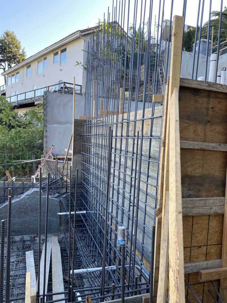 Reinforced steel framework at construction site.