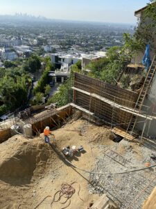 Cityscape view from urban construction site with worker.