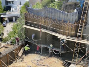 Workers at construction site with scaffolding.