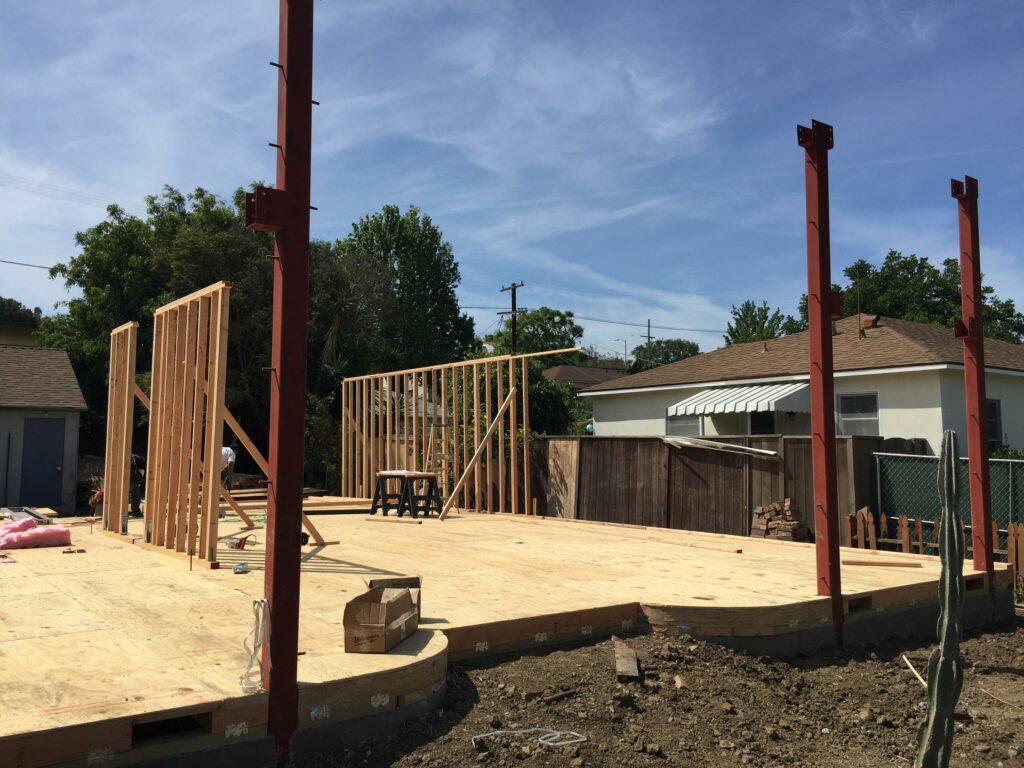 Residential construction site with framing in progress.