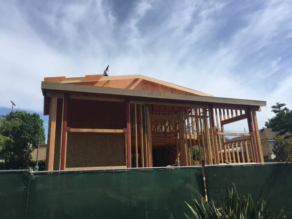 Wooden house frame construction under blue sky