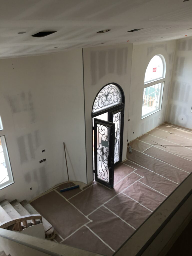 Interior home renovation, ornate front door, construction stage.