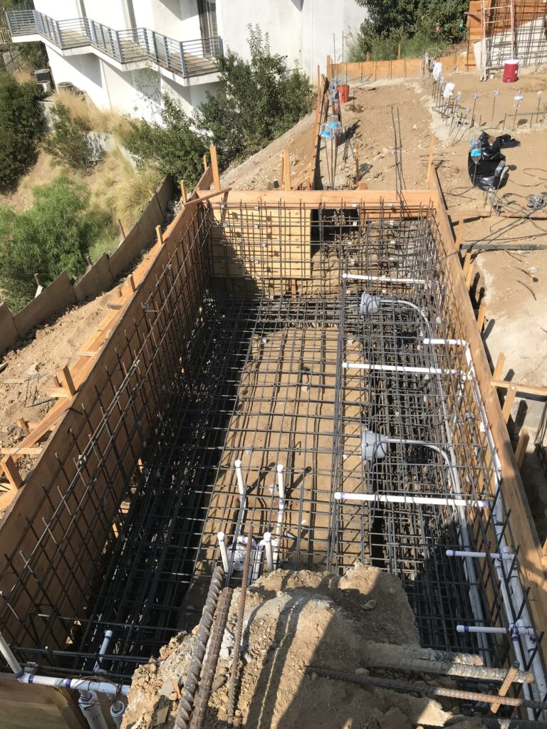 Construction site with foundational steel reinforcement setup.