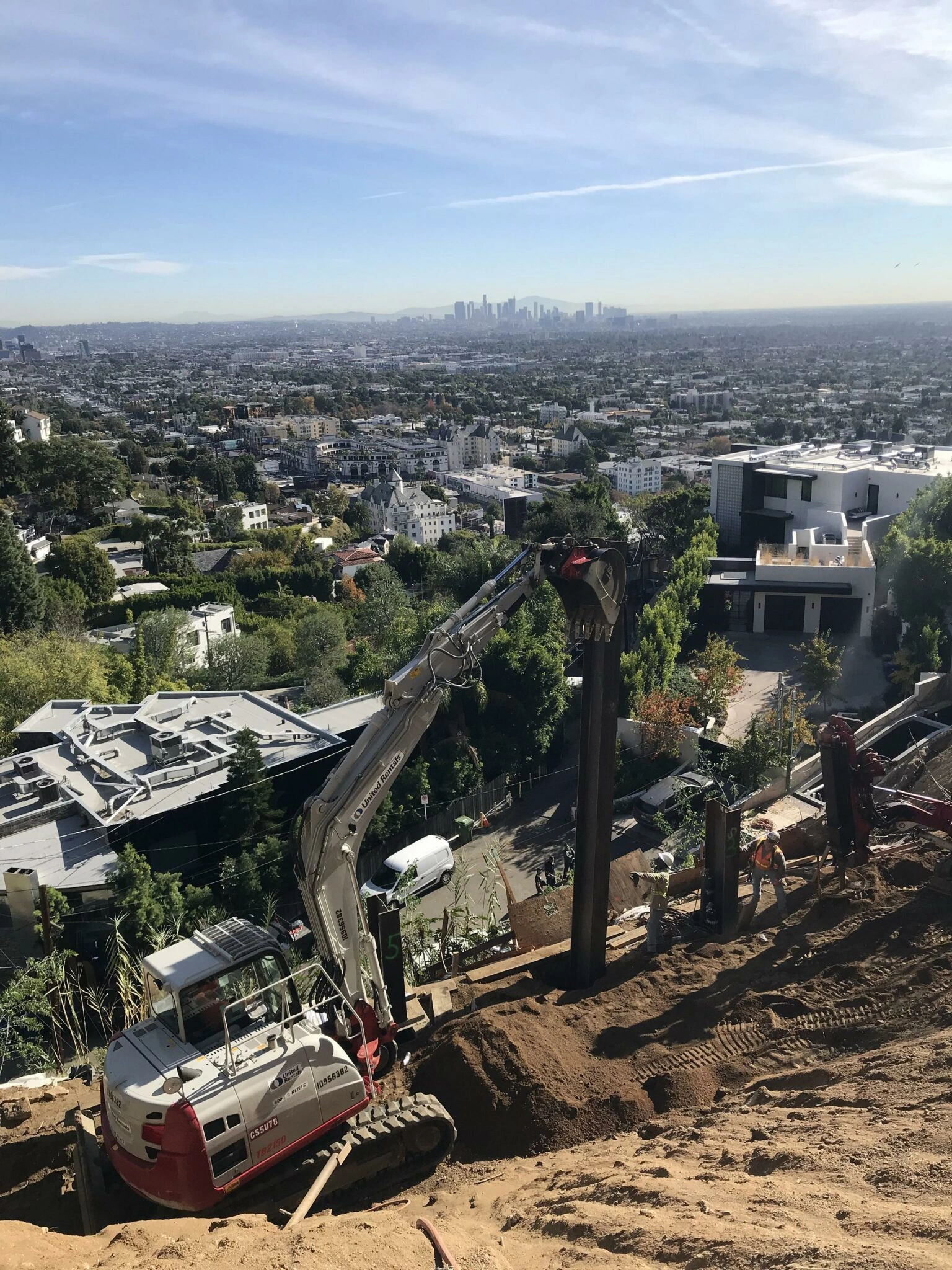 Construction site overlooking cityscape with clear skies.