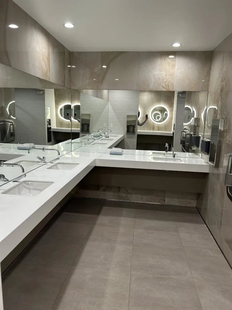 Modern marble bathroom interior with multiple sinks.