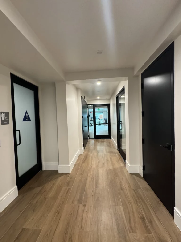 Modern corridor with wood flooring and lighting.