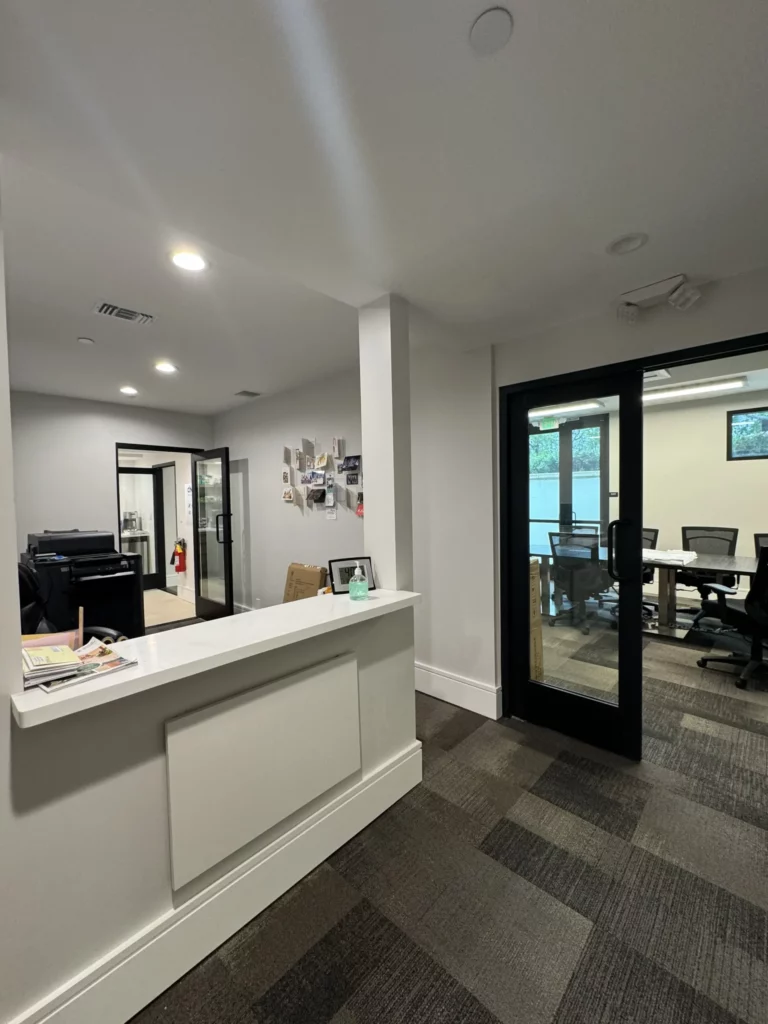 Modern office interior with reception and open door.
