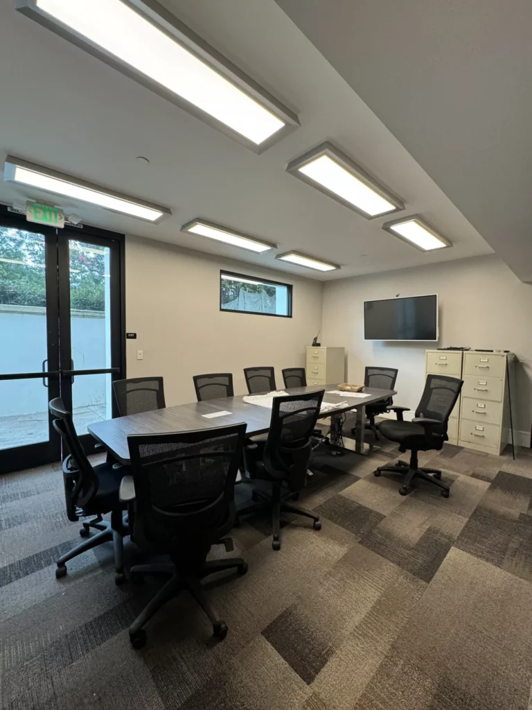 Modern office conference room with table and chairs.