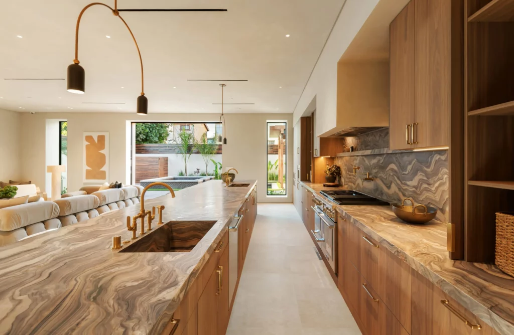 Modern kitchen with marble counters and wooden cabinets