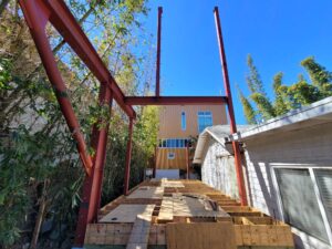 Construction site with red beams and wooden crates