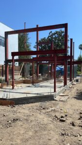 Construction site with red steel frame structure