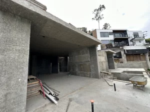 Concrete building under construction with materials scattered