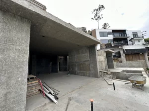 Unfinished concrete construction site with wheelbarrow