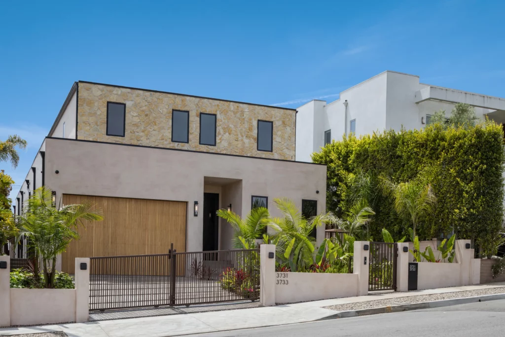 Modern two-story house with stone facade and landscaping
