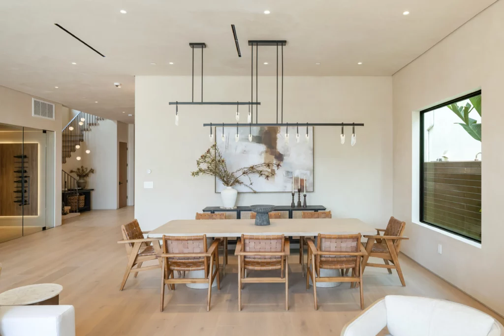 Modern spacious dining room with stylish decor and artwork