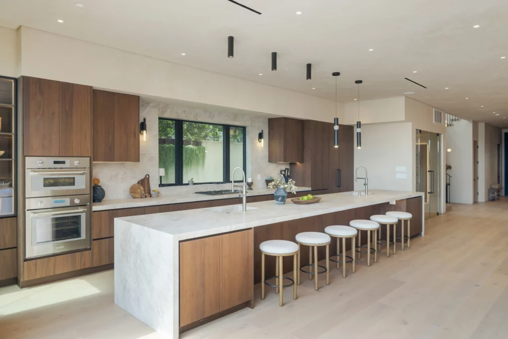 Modern kitchen with wooden cabinets and marble island