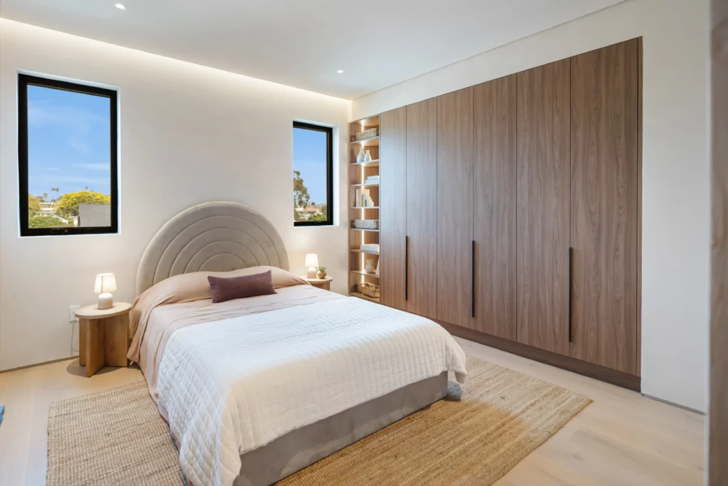 Modern bedroom with large bed and wooden furniture