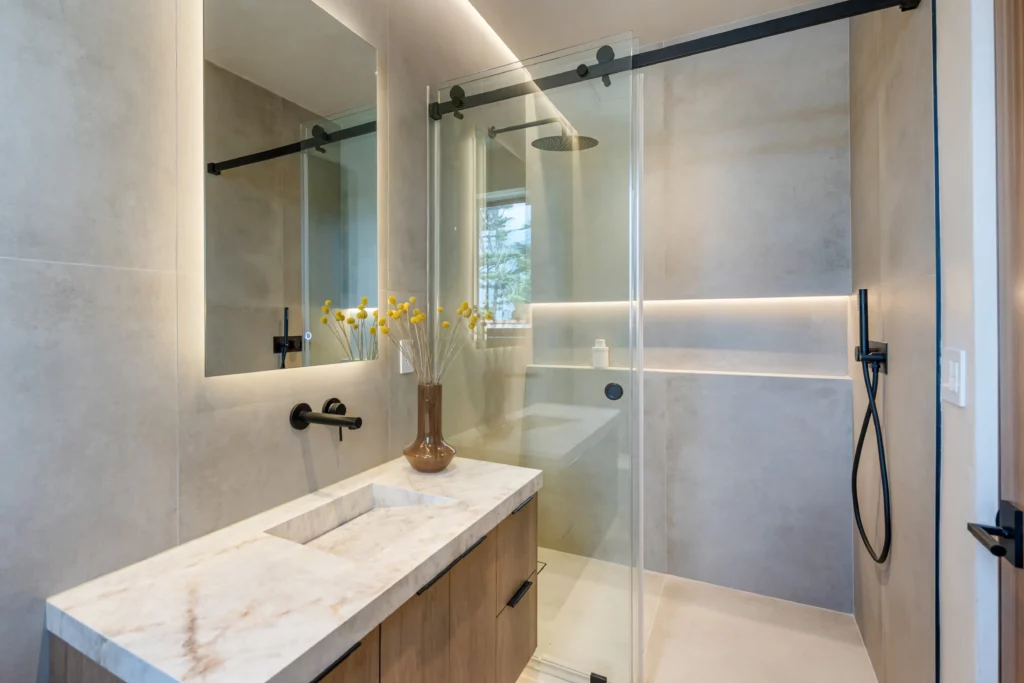 Modern bathroom with glass shower and marble sink