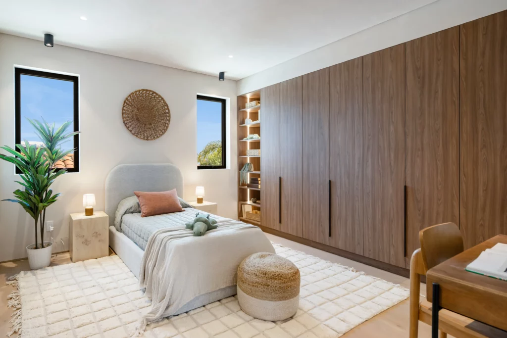 Modern bedroom with plush bedding and wooden accents