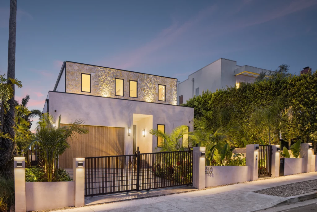 Modern house exterior at dusk with illuminated windows