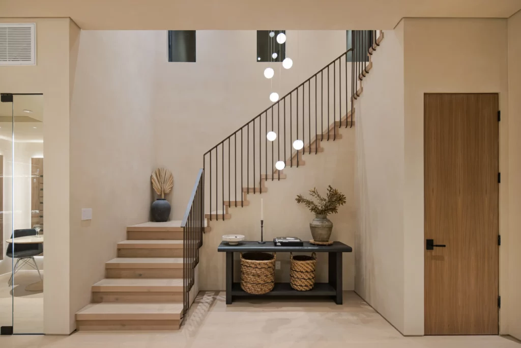 Modern staircase with hanging lights in stylish home interior