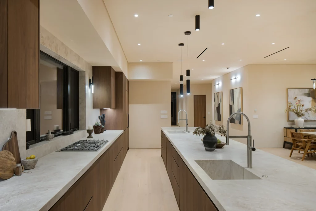 Modern kitchen with wooden cabinets and marble countertops